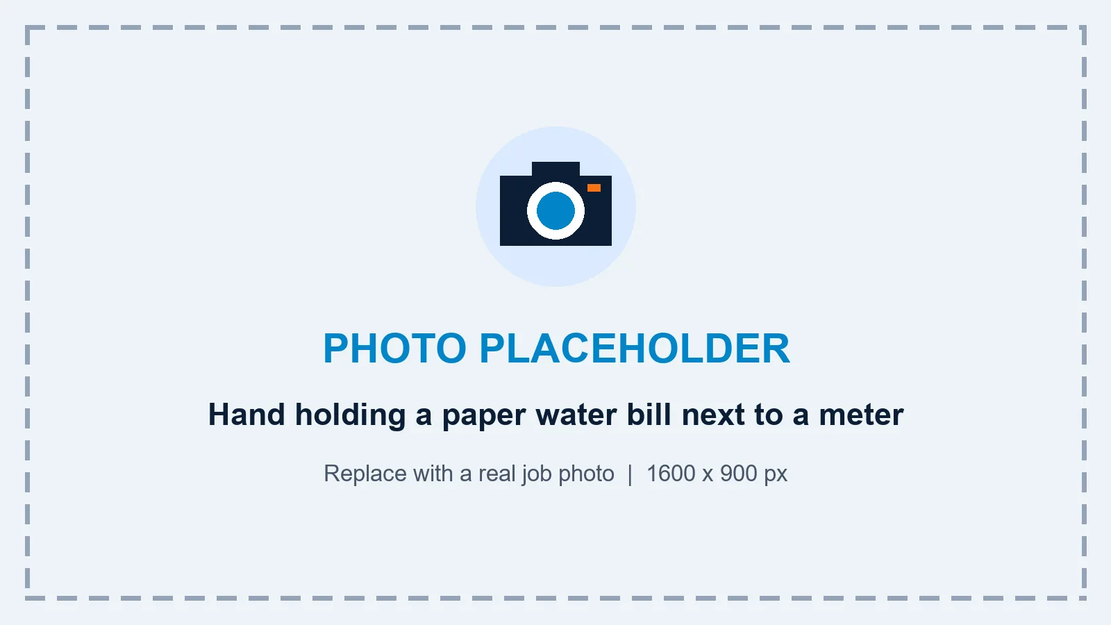 Hand holding a paper water bill next to a water meter